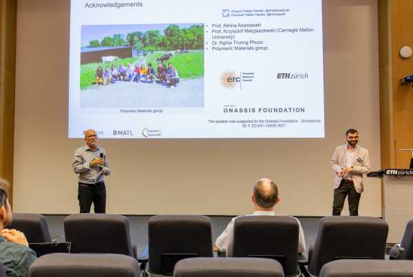 ession chair Prof. Ralph Müller (D-HEST) and Kostas Parkatzidis (D-MATL) in front of the Audi Max screen