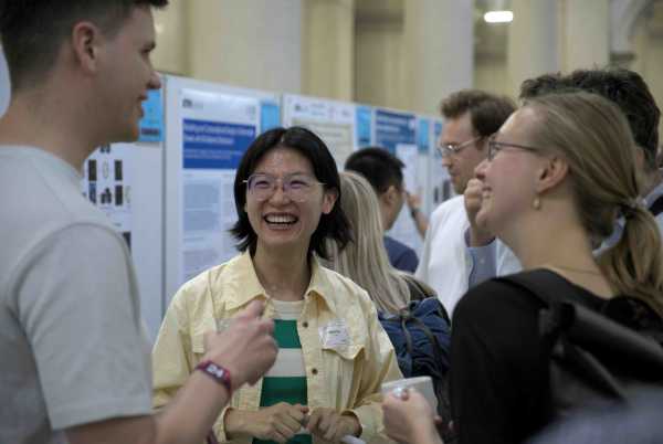 Two women and one man discussing and smiling at each other