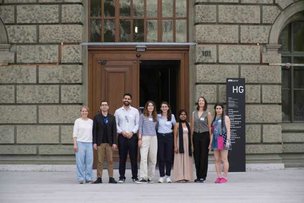 8 people lined up in front of the door of ETH Zentrum's main building