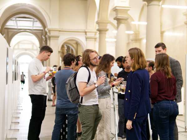 Doctoral students discussing and networking during the symposium