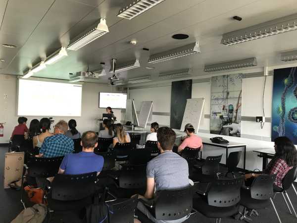 A typical seminar situation with one speaker and people in the audience from behind