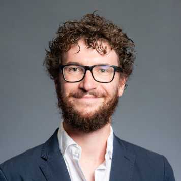 Portrait of a young male with beard and glasses