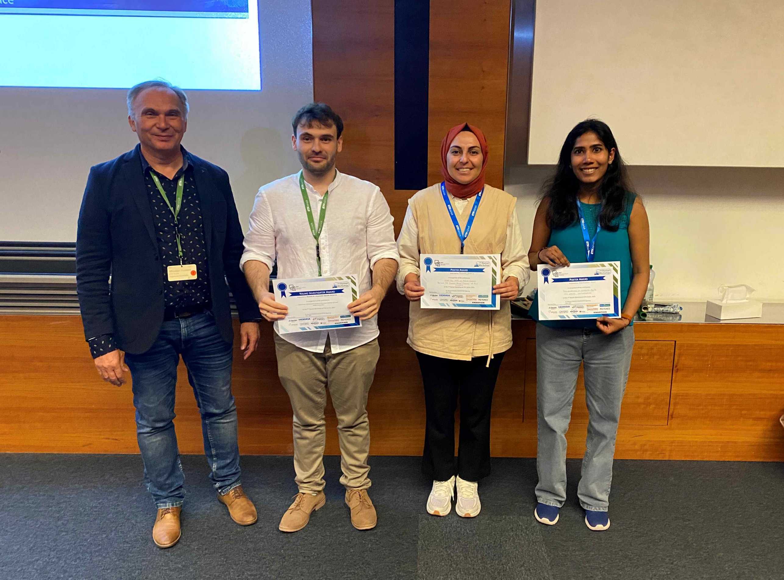 Miro Haluska, chair, with the three poster prize winners holding up their certificates