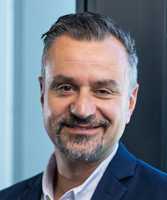 A portrait picture of a middle-aged caucasian man with beard
