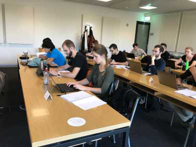Students coding on their laptops during the course in Advanced Machine Learning