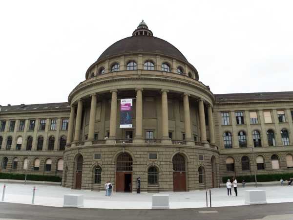 ETH Zentrum main building seen from outside. A banner for MaP Graduate Symposium hanging above the door