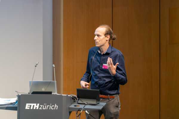 Presenter standing behind lecture desk