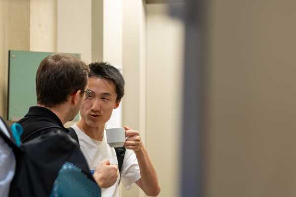 two people chatting, drinking coffee