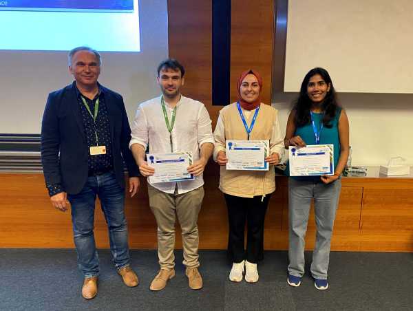 Chair M. Haluska with the three poster prize winners